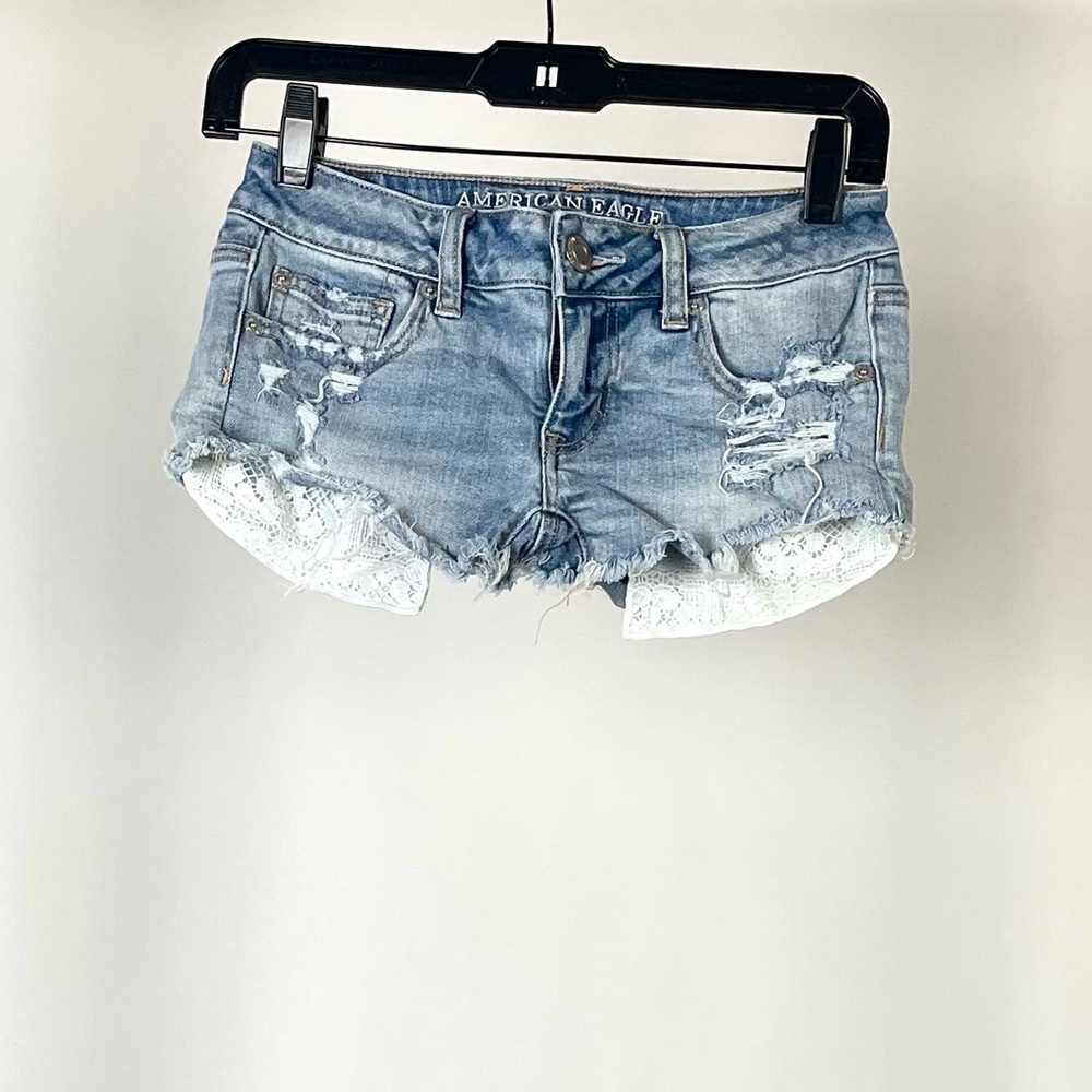 AE Daisy Duke Cutoffs Distressed Light Wash revealing pockets in light blue.